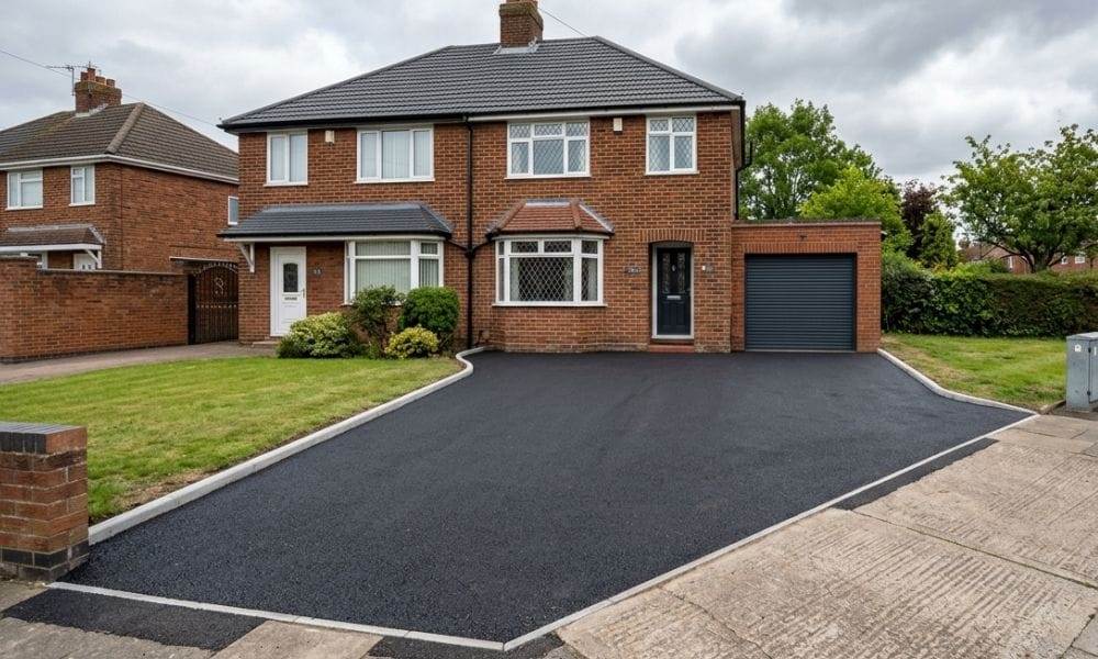 A freshly laid tarmac driveway on a residential property in a typical Stoke-on-Trent street setting.